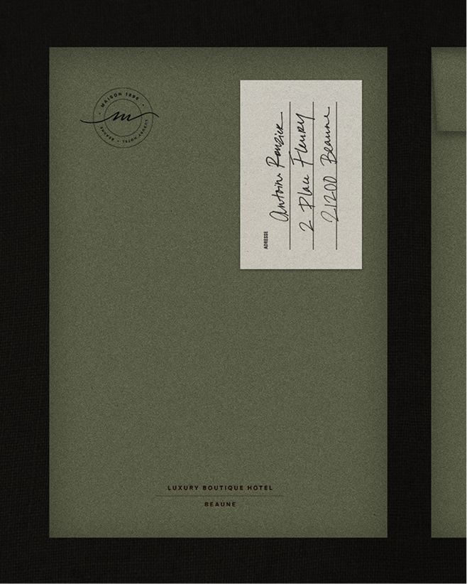 Olive-green envelope with Maison 1896 seal and handwritten address card
