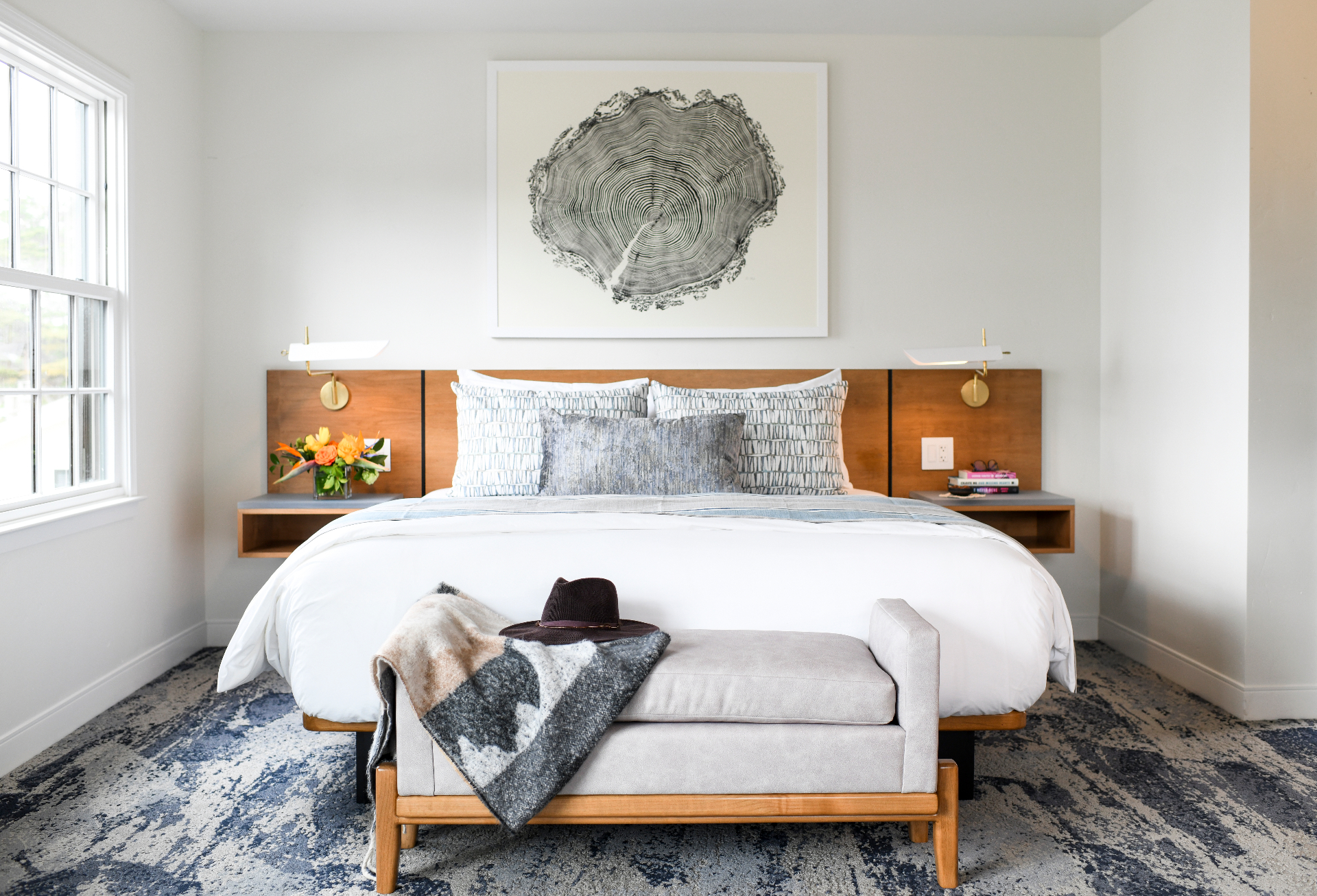 Carmel Beach Hotel guest room with linen bedding, warm wood, and coastal light — Carmel-by-the-Sea, California