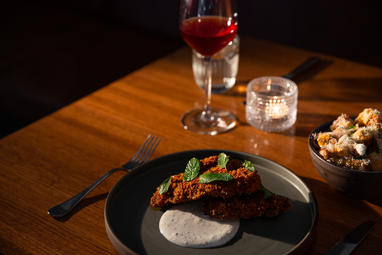 Candlelit dinner plate with wine