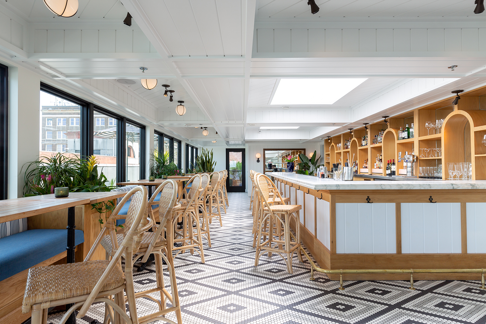 The Drayton — sunlit rooftop bar with tile floor