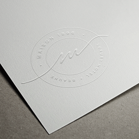 Blind-embossed Maison 1896 seal on cream stock
