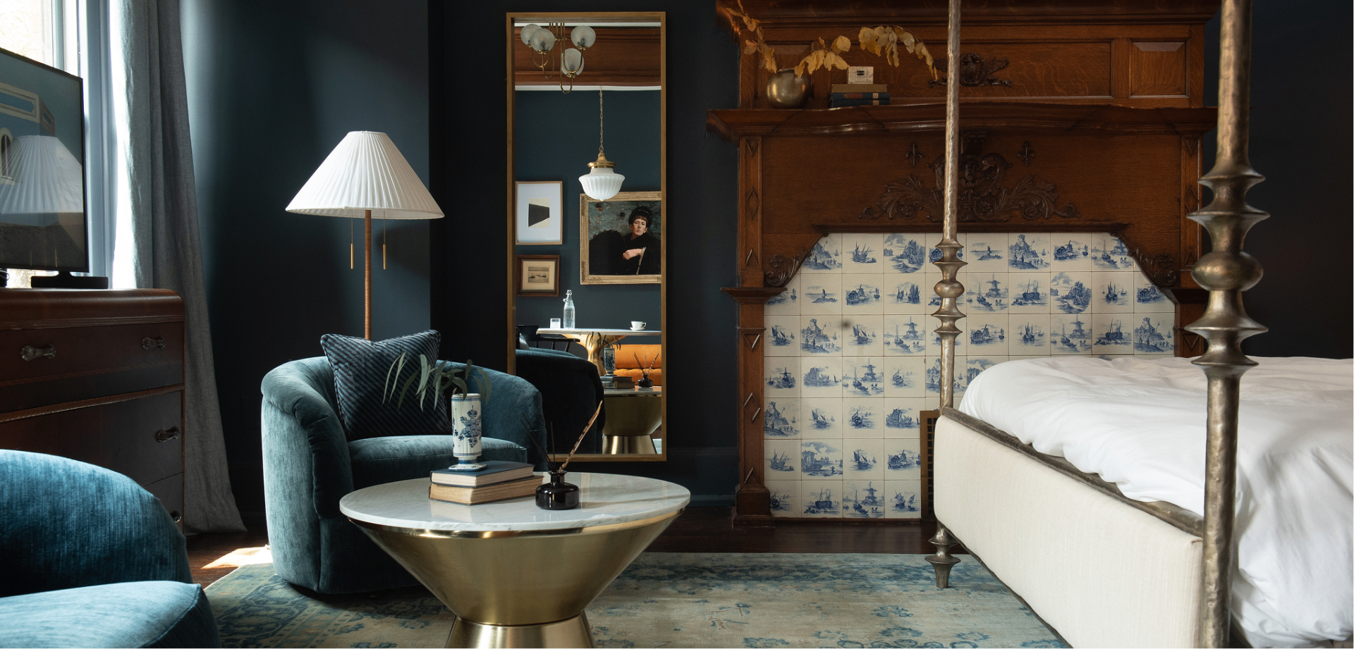 Guild House Hotel — guest room with four-poster bed and Delft-tile fireplace